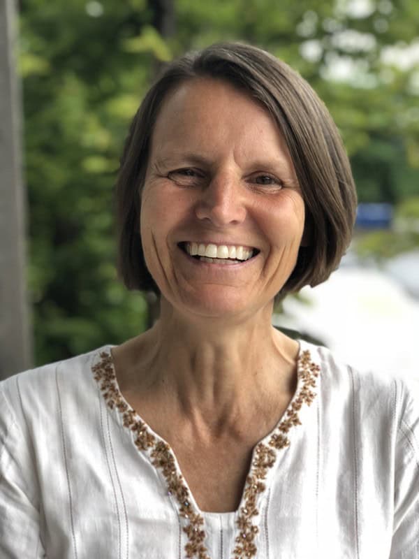 portrait of person smiling, wearing white shirt