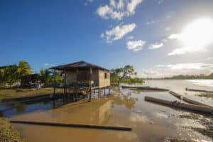 Flooded houses and boats in a Latin American riverside community.