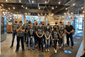 Group of volunteers wearing masks at Lighting the Way event.
