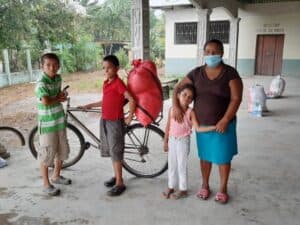 Family receiving aid during recovery efforts in a rural area.