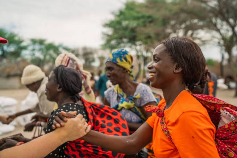 Women engaging in community support to challenge gender-based violence.