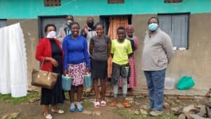 Young people and community members gathered outdoors in Uganda