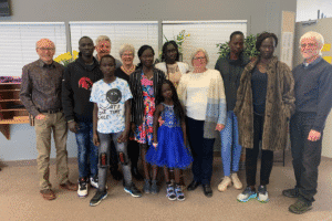 Diverse group of people at a community event for World Renew.