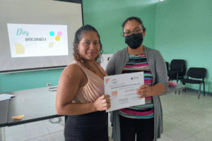 Two women holding a certificate at a World Renew event.