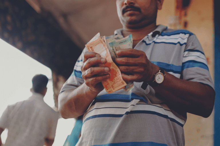 Man counting cash, representing financial aid and support from World Renew.