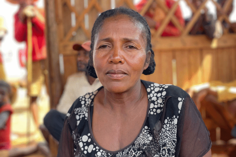 Woman in community support event, representing aid and resilience.