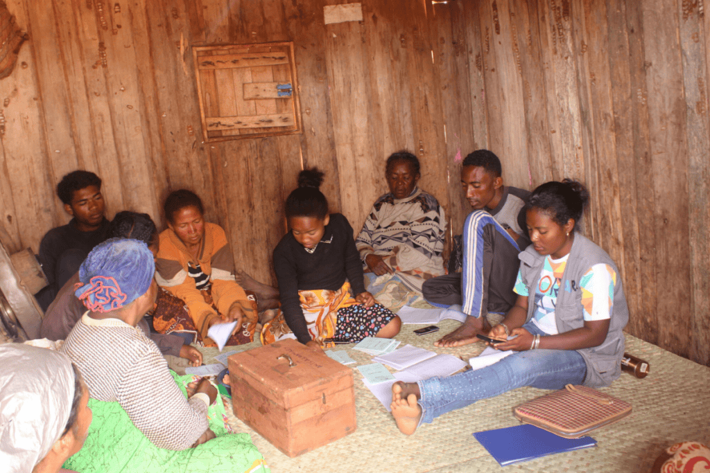 Group of people gathered indoors for a community discussion in Madagascar.