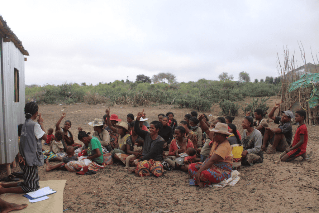 Community gathering in Madagascar for local development and education.