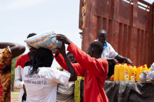 People receiving aid supplies from World Renew in a community setting.