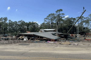 Collapsed building and damaged infrastructure after a natural disaster.