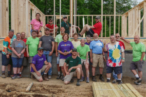 Group of volunteers building a wooden structure for community development.