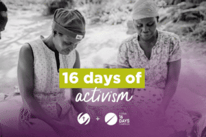 Two women participating in a community activism event by a riverbank.