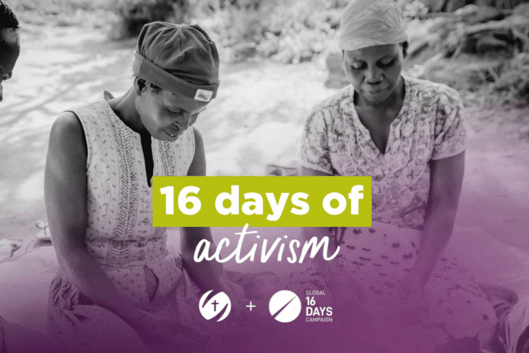 Two women participating in a community activism event by a riverbank.