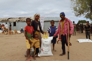 Community members receiving aid from World Renew in a rural setting.