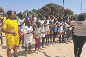Children and adults participating in a community event outdoors.