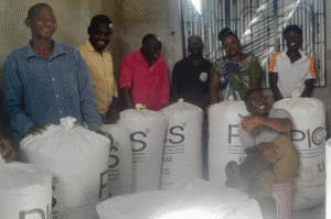 Group of people distributing aid supplies in a community center.