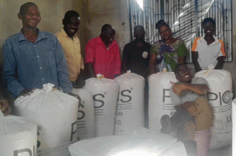 Group of people distributing aid supplies in a community center.