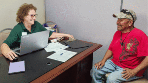 Woman and man engaging in a supportive conversation at a community center.