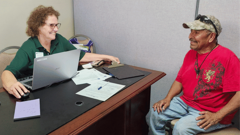 Woman and man engaging in a supportive conversation at a community center.