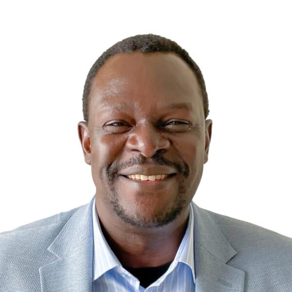 Smiling man in a suit representing community and hope.