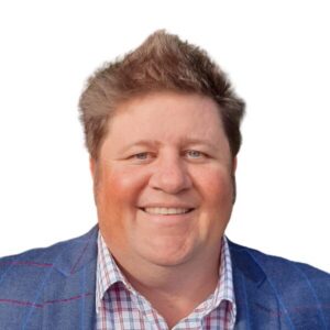 Smiling man in a blue blazer and checkered shirt for World Renew.