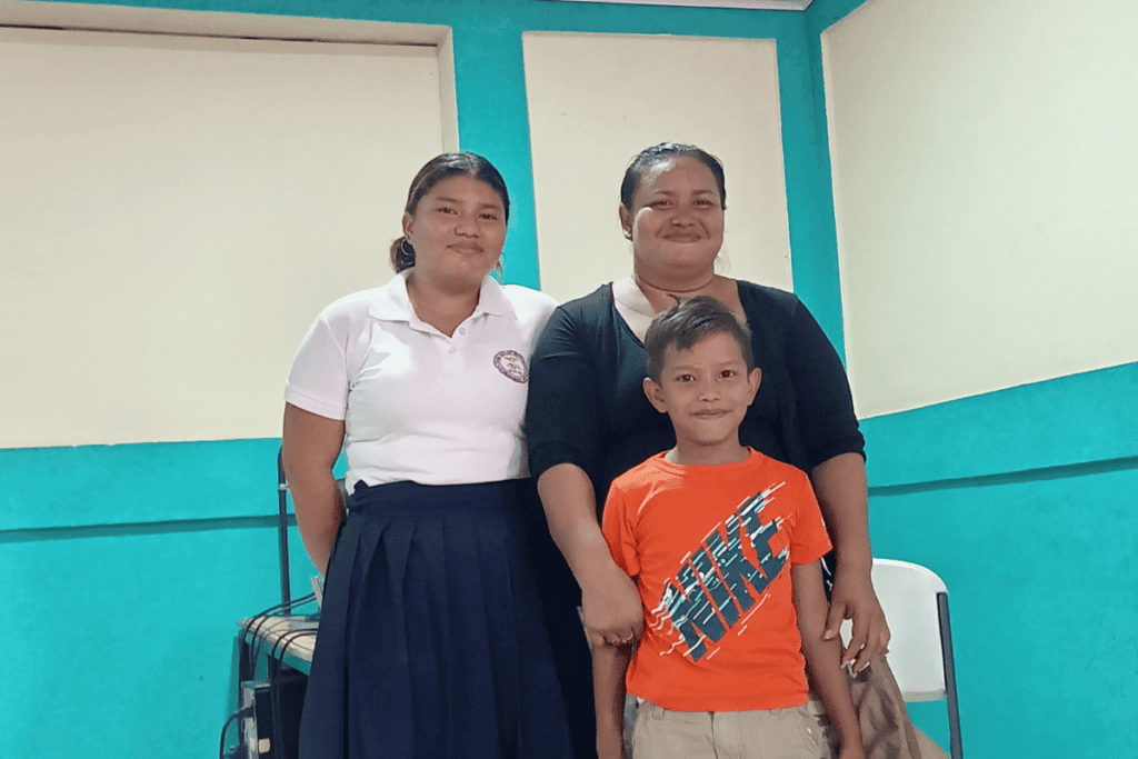 Group of women and a boy in a community center for support activities.