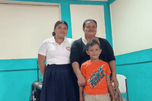 Group of women and a boy in a community center for support activities.