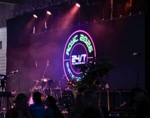 Stage setup at AOYC 2026 youth event with logo and musical instruments.