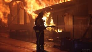 Firefighter battling flames during California wildfire response.