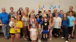 Group of diverse people including children and adults at World Renew event.