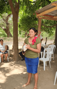 Woman holding a white object during community gathering in Nicaragua.
