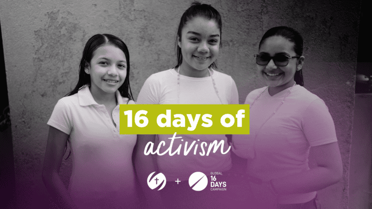 Three girls smiling at an activism event promoting gender equality.