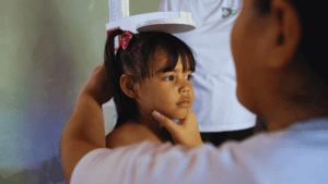 Young girl getting a health checkup during a medical outreach in Honduras.