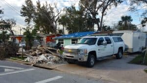 Emergency response vehicle and debris after Hurricane Ian.