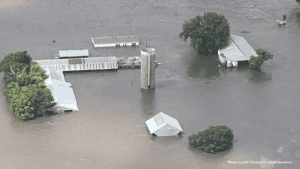 Flooding in Iowa with submerged buildings and trees.