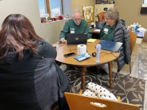 People discussing flood recovery efforts at a community center.