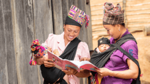 Women and child in rural Laos, engaging in community health education.