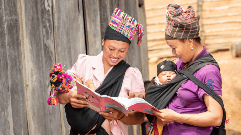 Women and child in rural Laos, engaging in community health education.