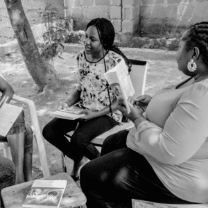 Women engaging in discussion about gender-based violence prevention.