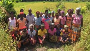 Community members stand together beside a rice field in Koikoro, Sierra Leone.