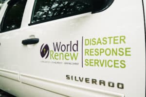 World Renew Disaster Response Services logo displayed on the side of a white response vehicle.
