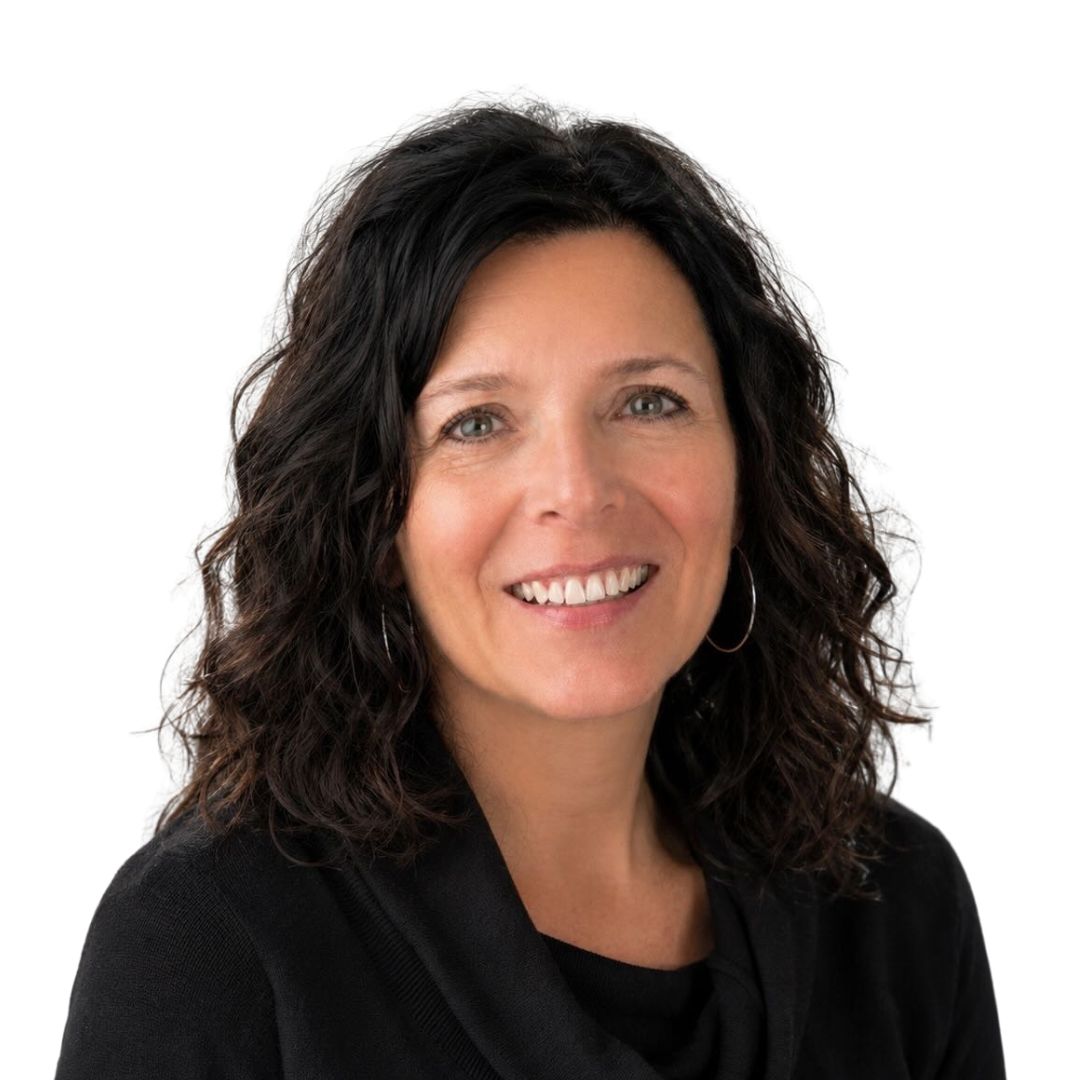 Head-and-shoulders portrait of Christi Schaefbauer wearing a black top against a light background.